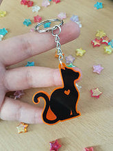 Load image into Gallery viewer, Black Cat 2 in Orange UV Acrylic Charm
